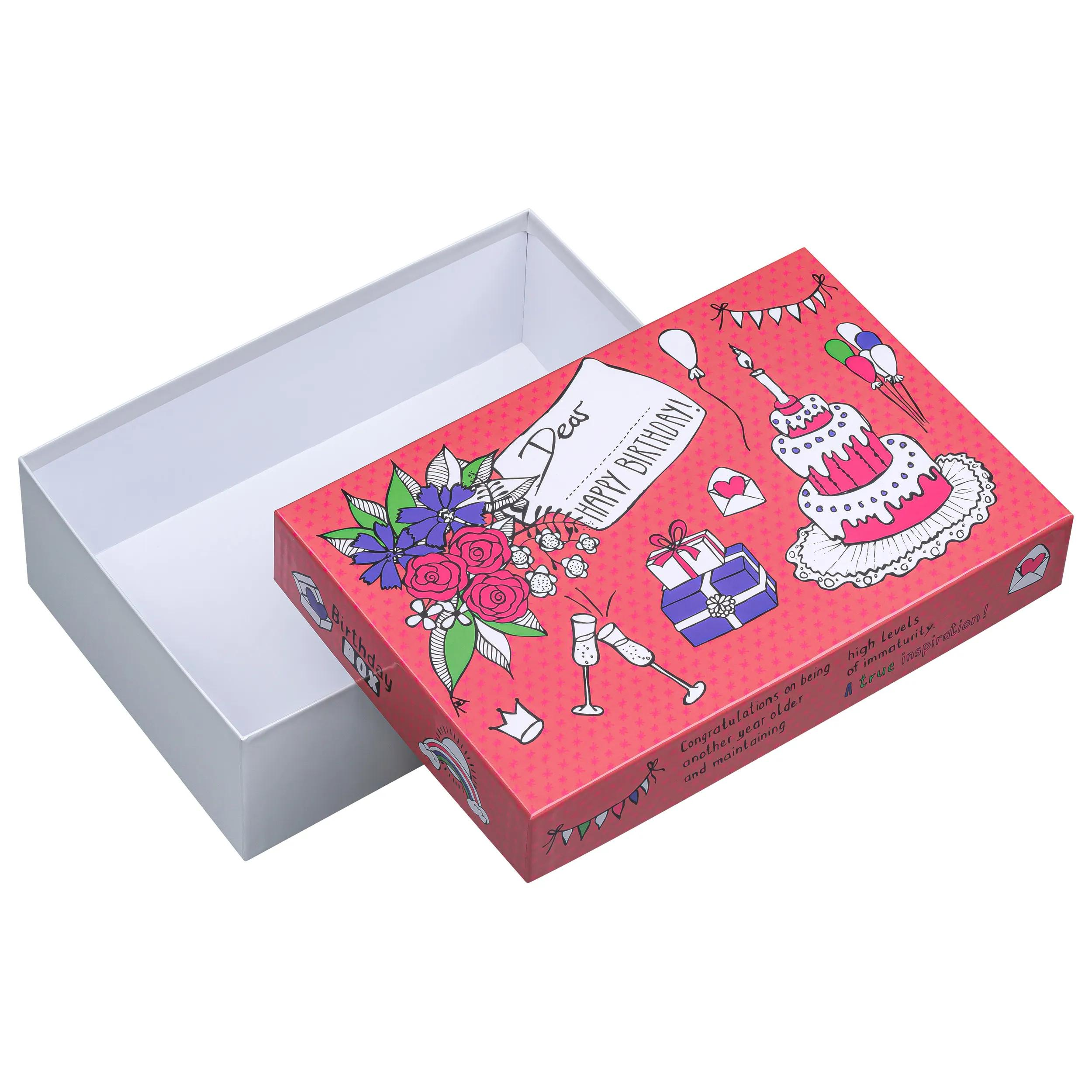 Una caja de regalo rosa abierta con motivos de cumpleaños como pastel, globos y flores.