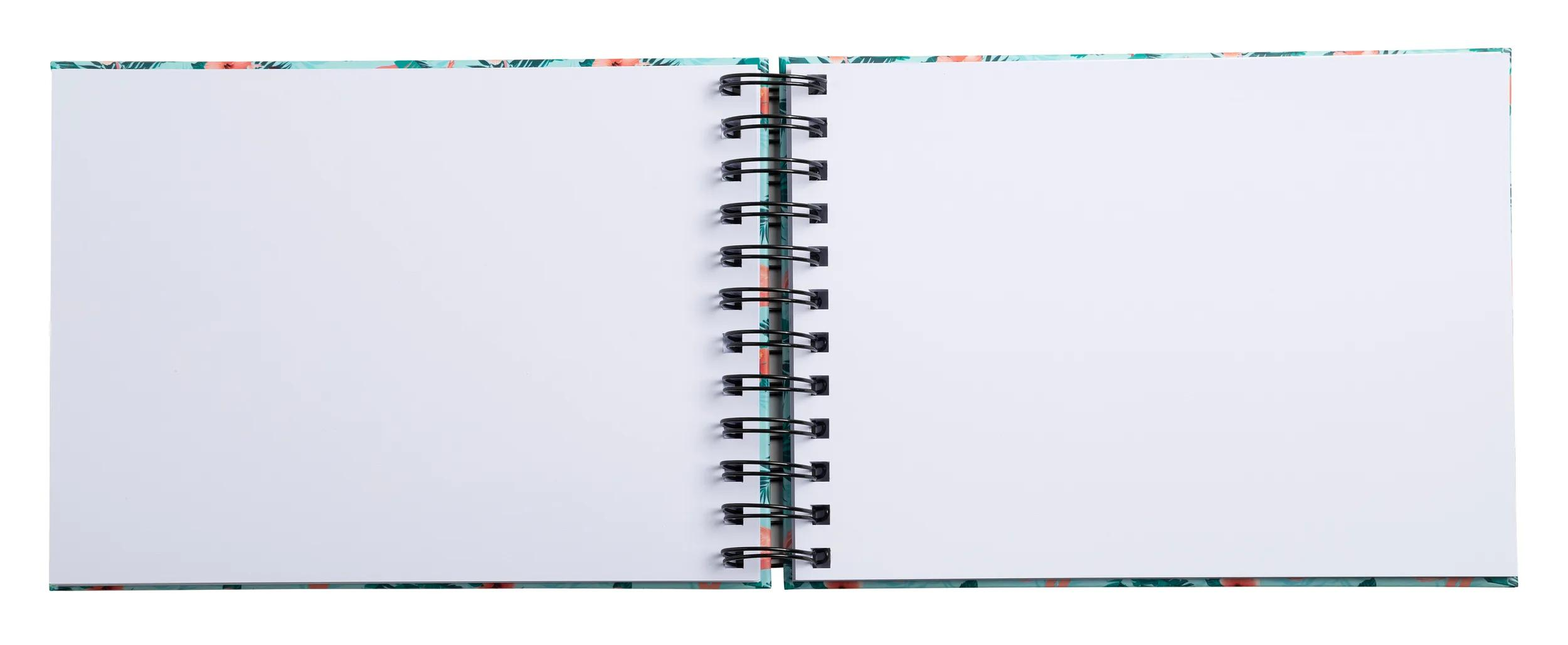 Un cuaderno abierto con un patrón tropical en la cubierta y páginas en blanco.
