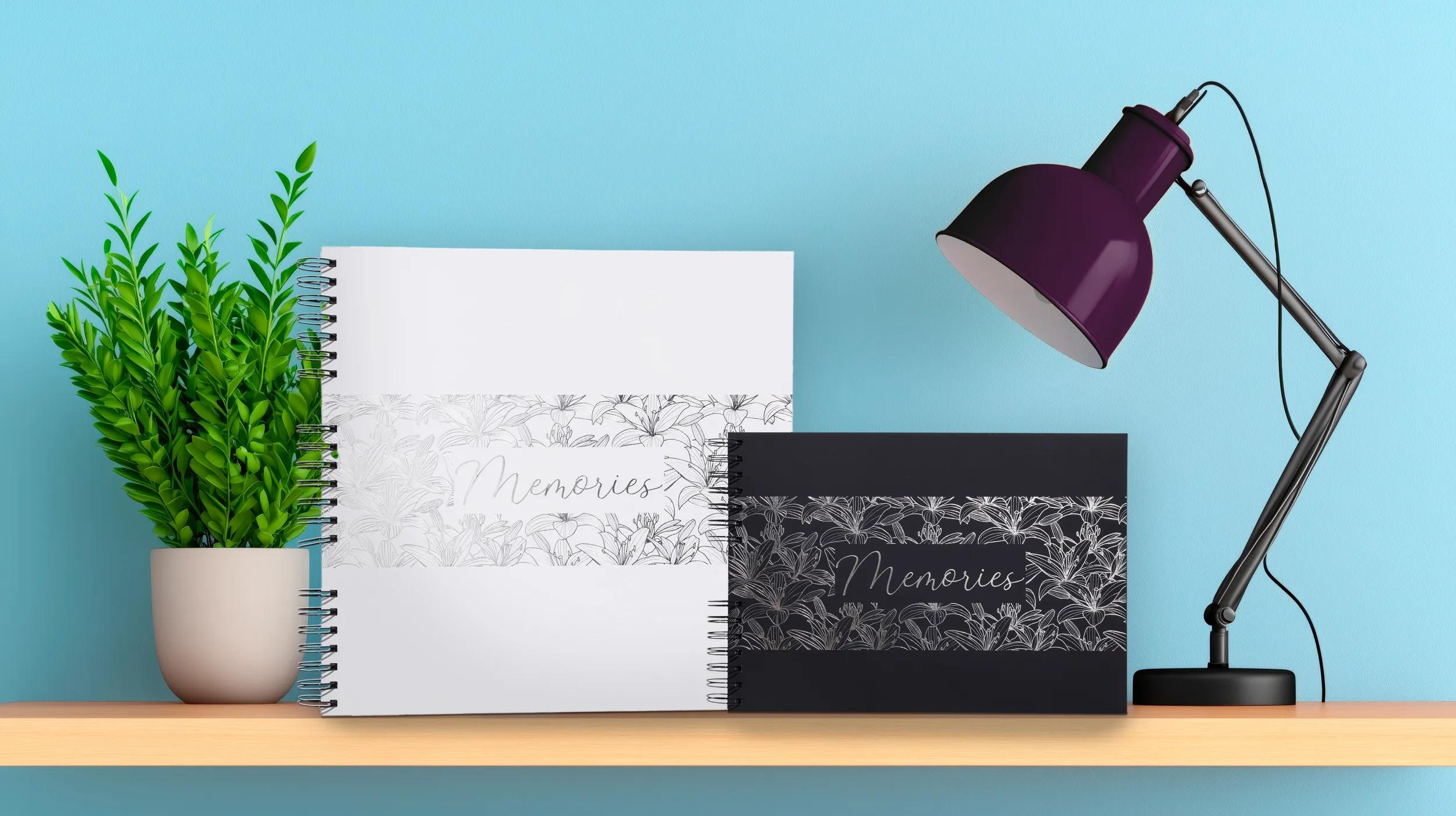 Dos cuadernos con estampado floral y la palabra “Memories” en un estante.