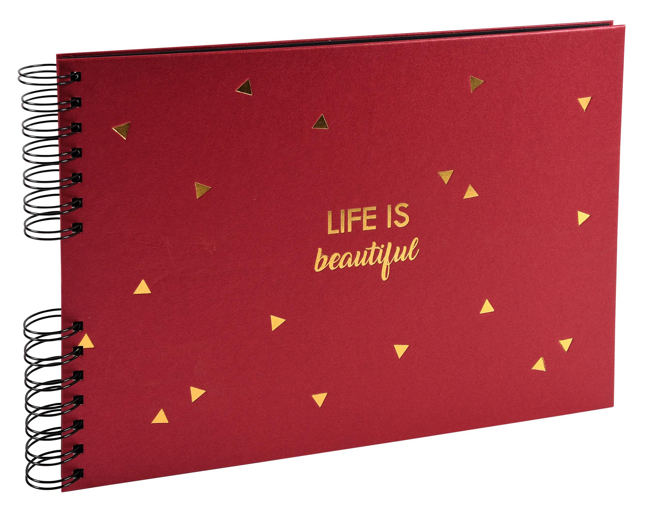 Cuaderno rojo con espiral y triángulos dorados. Texto: Life is beautiful.