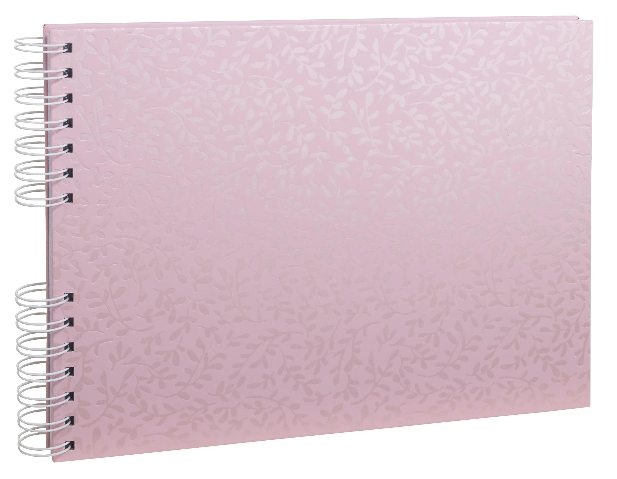 Un cuaderno rosa claro con patrón de hojas y encuadernación en espiral blanca.
