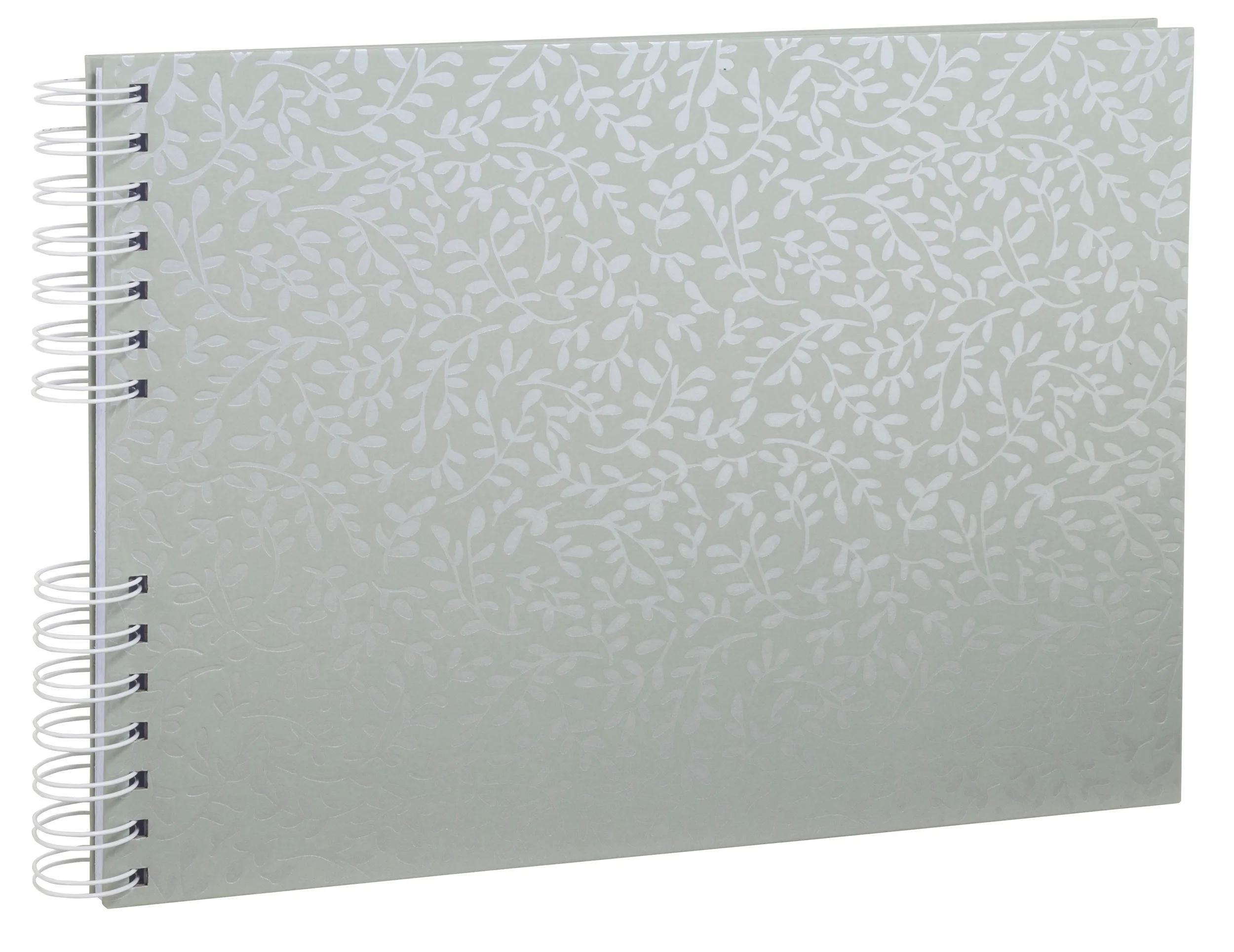 Un cuaderno verde claro con estampado de hojas y espiral blanca.