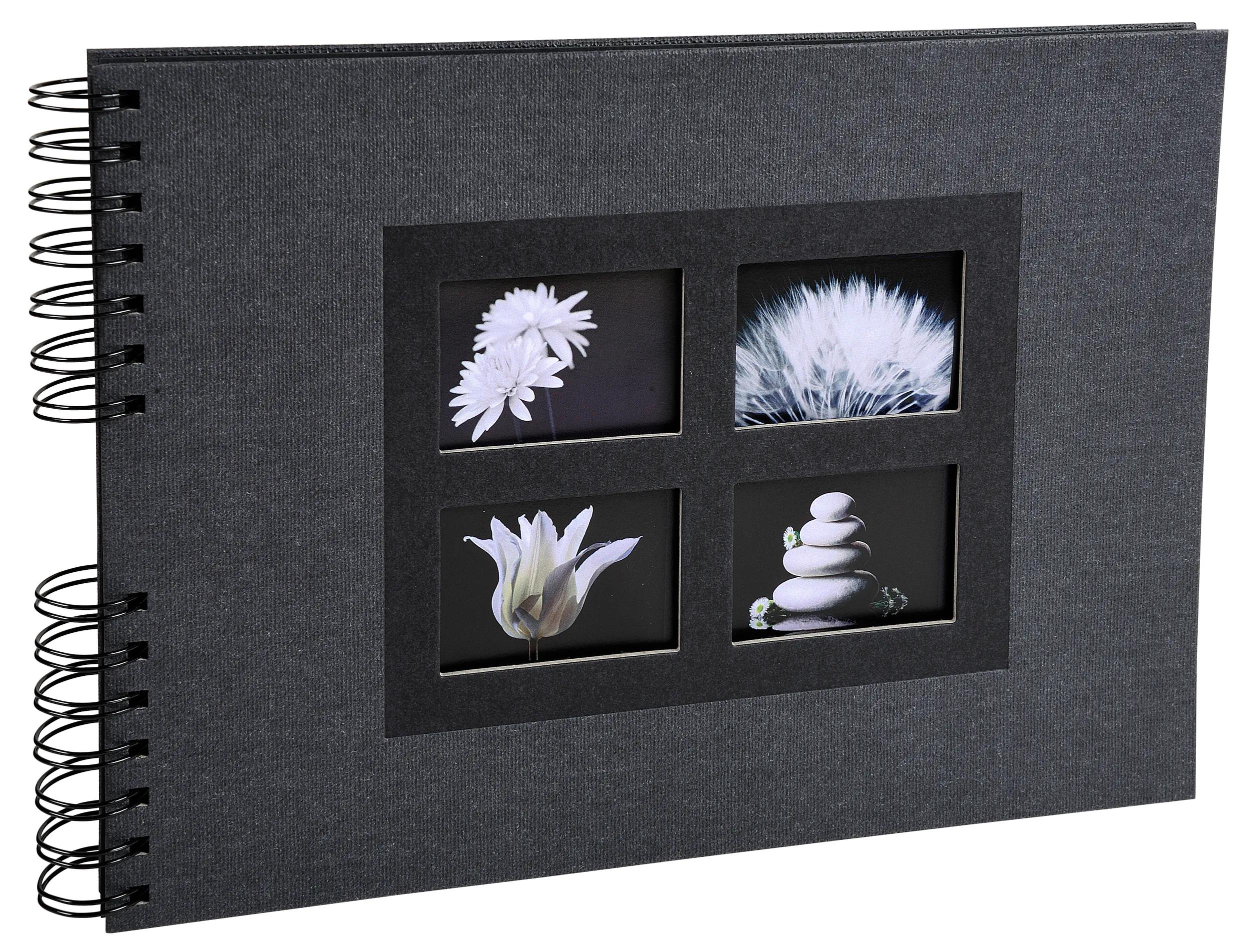 Álbum negro con espiral y cuatro recortes: flores, diente de león, tulipán blanco, pirámide de piedras.