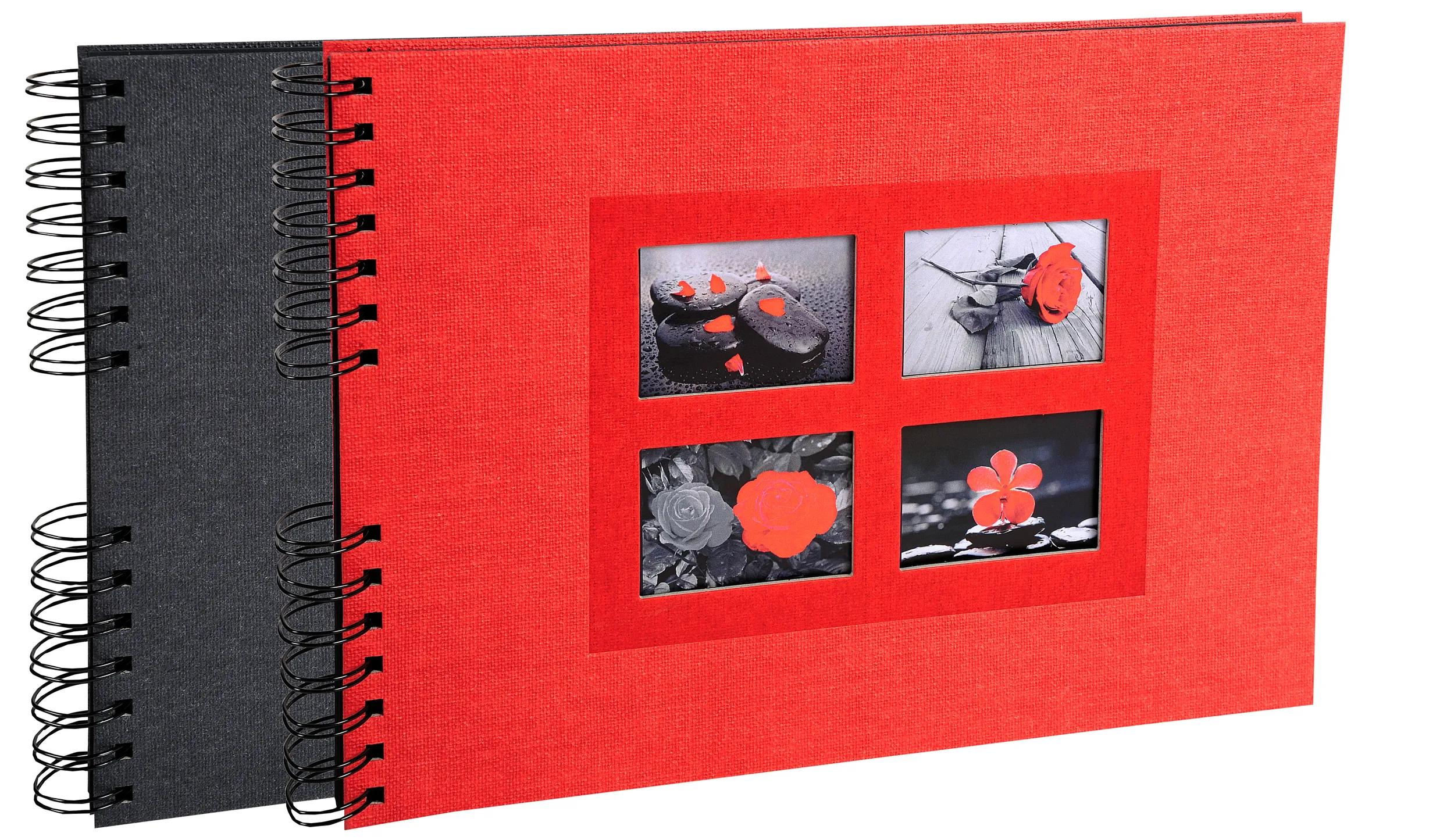 Un álbum de espiral negro y uno rojo con cuatro recortes de fotos en la portada roja.