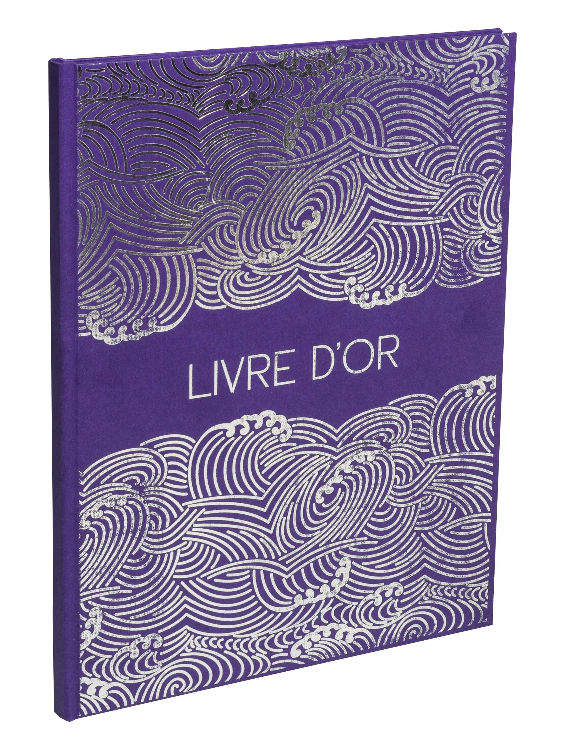 Un libro morado con patrón de olas plateadas y “LIVRE D’OR”.