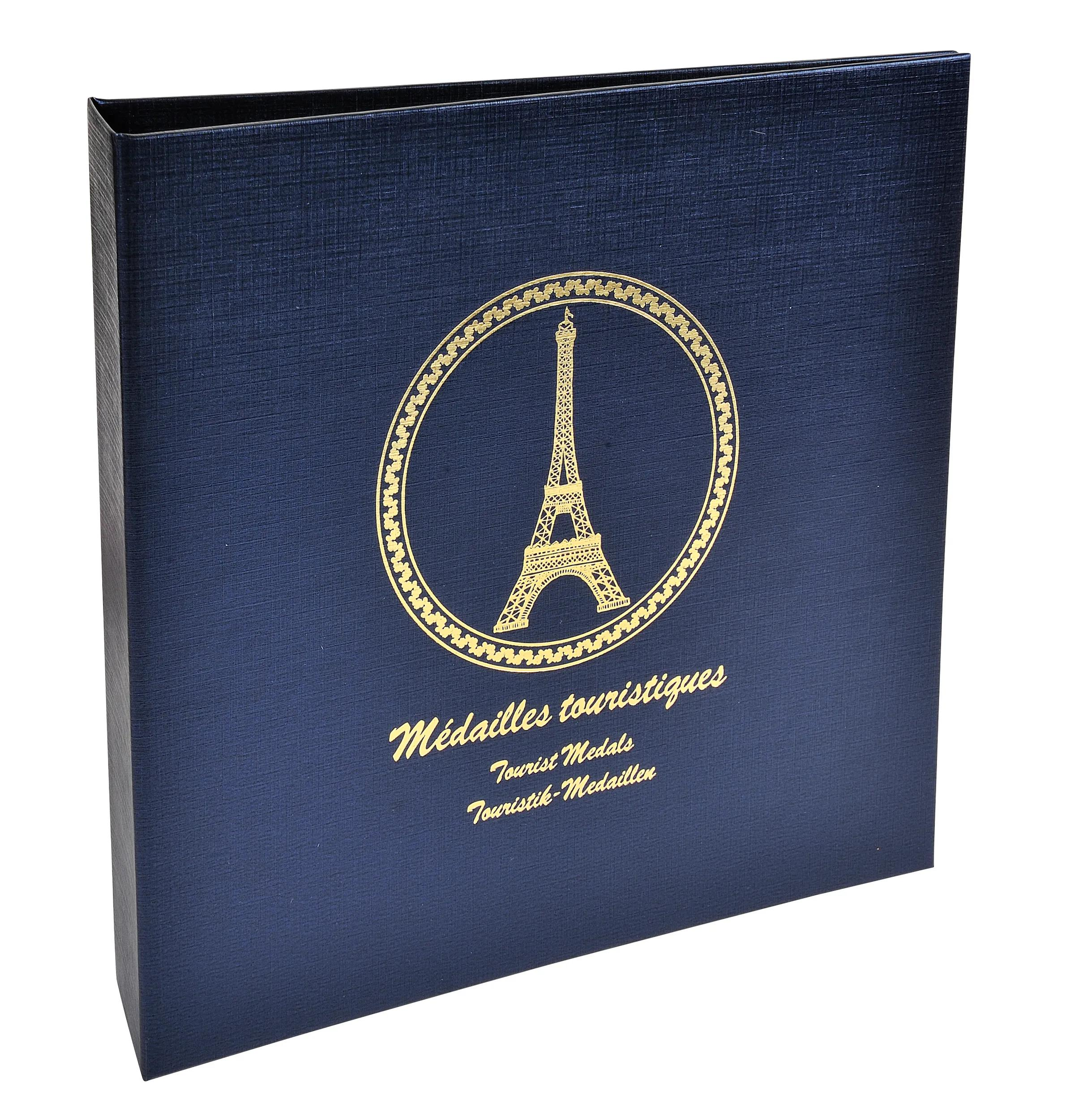Caja azul oscuro con grabado dorado de la Torre Eiffel y texto.