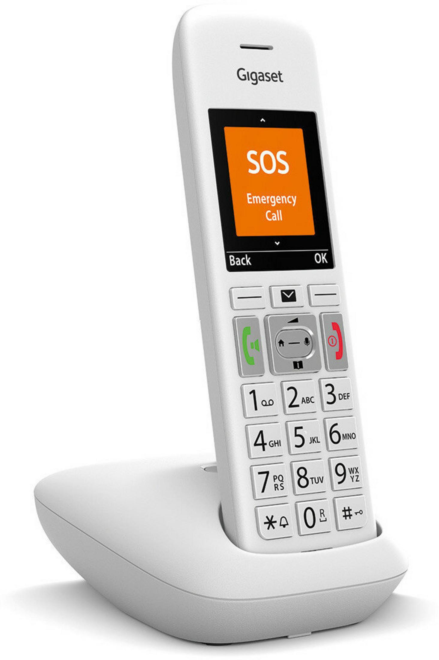 Biały telefon Gigaset z funkcją alarmowego połączenia SOS stoi na stacji ładującej.