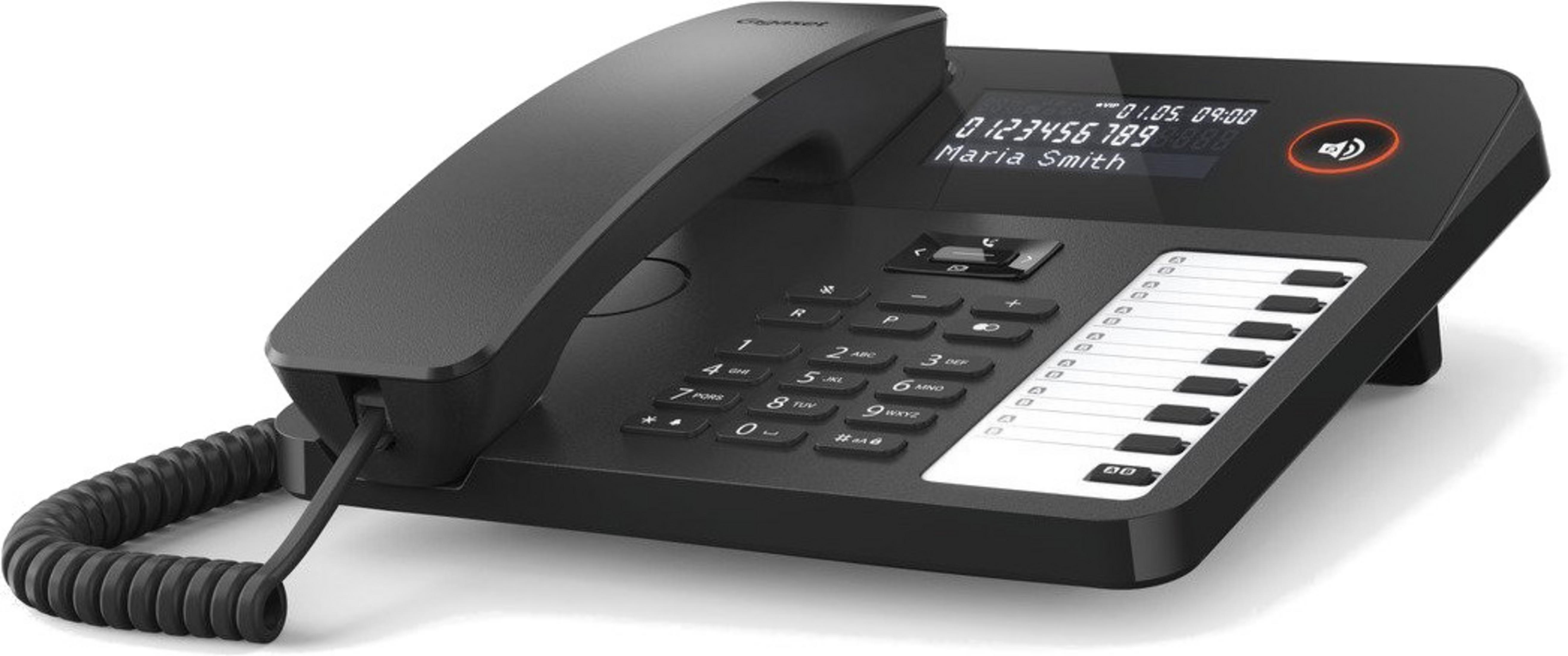 Un telefono cordless nero con display illuminato e tastiera. Su superficie bianca.
