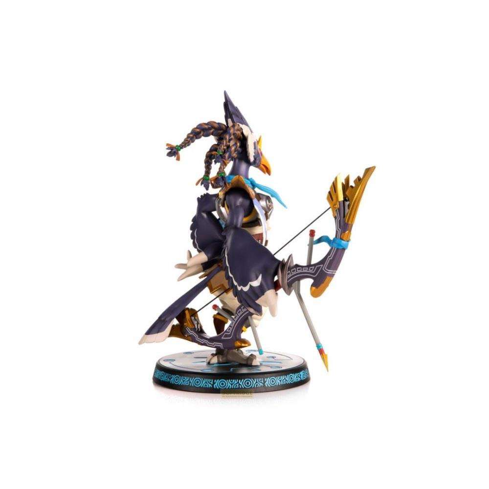 Une figurine avec arc et flèche, bleu foncé et doré, se tient sur une base ronde.