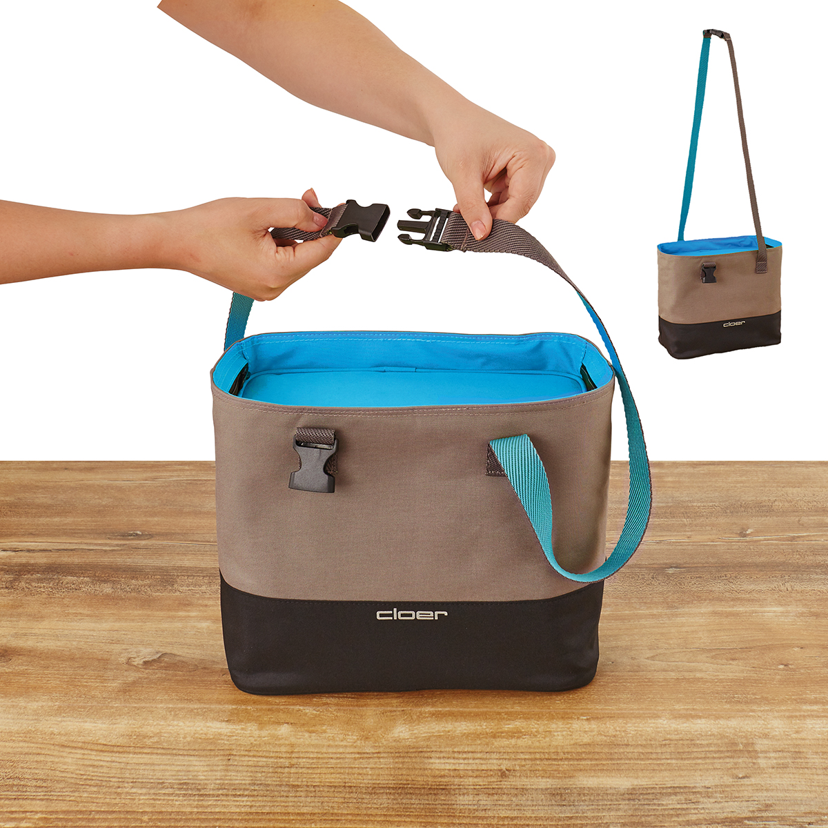 Zwei Hände verbinden einen Trageriemen mit einer braunen und schwarzen Kühltasche.