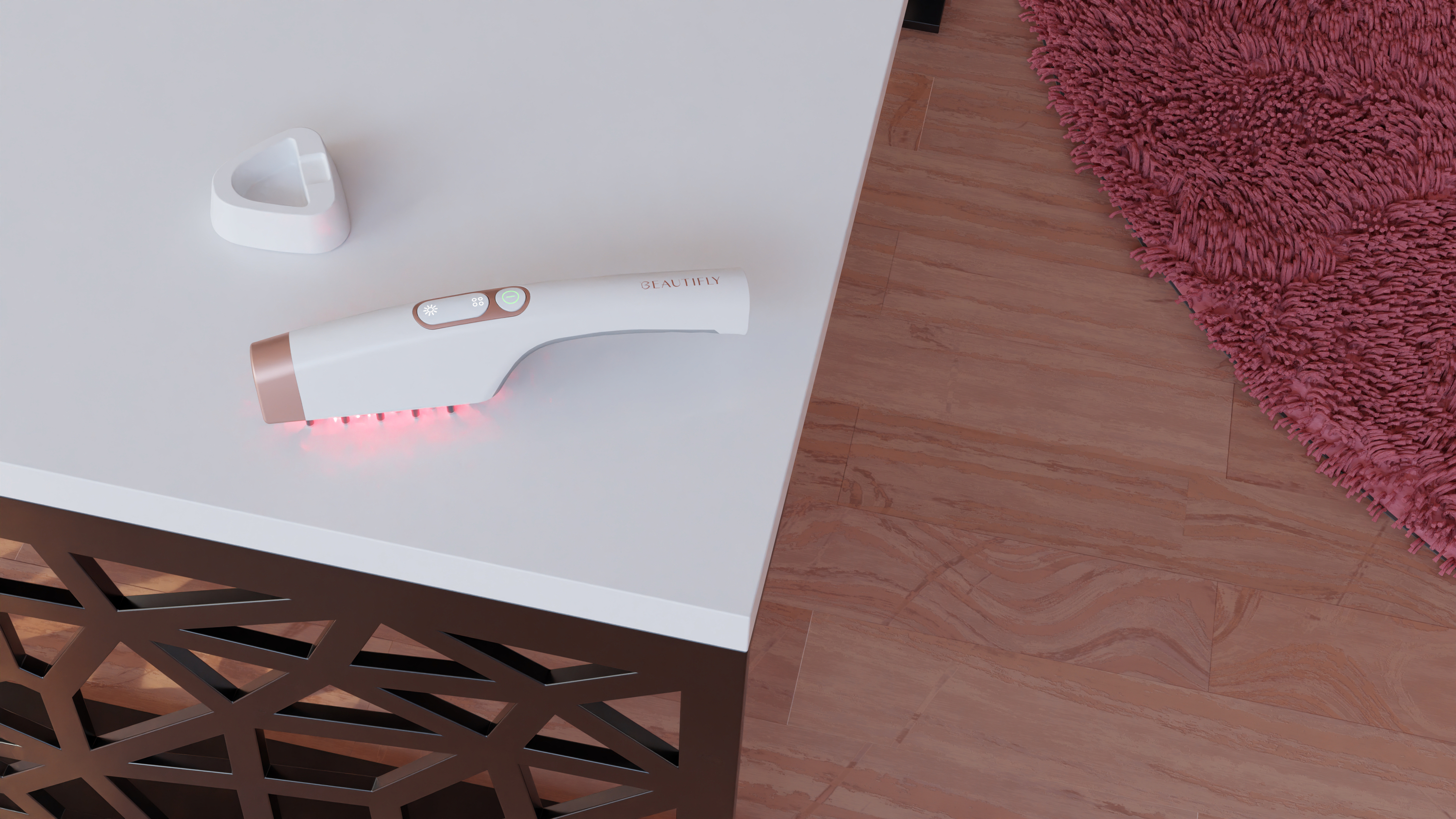 Un dispositivo blanco con detalles en oro rosa y luces rojas sobre una mesa.