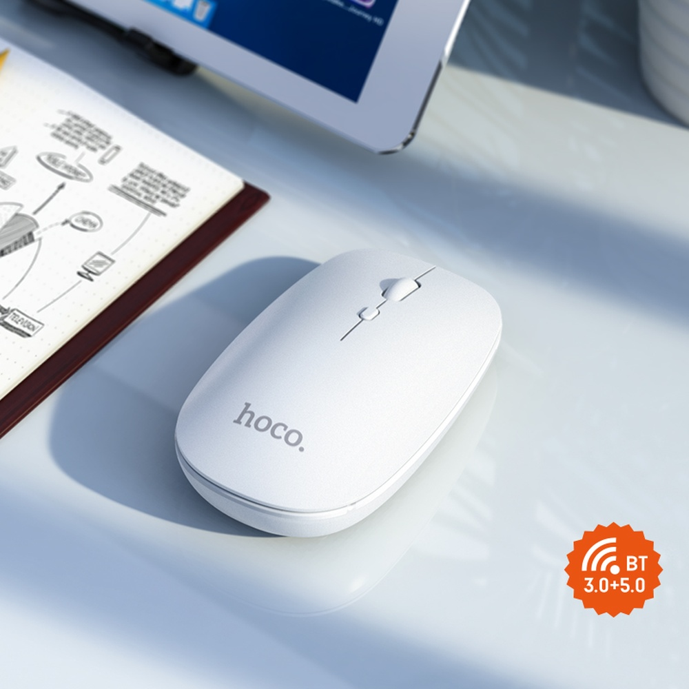 Ratón blanco hoco con logo BT 3.0+5.0 junto a un cuaderno.