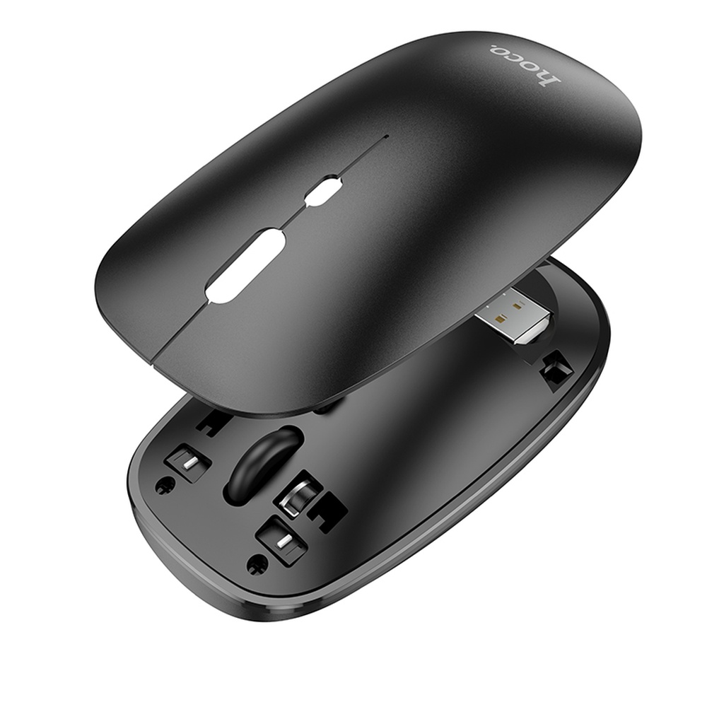 Ratón de ordenador negro con receptor USB y componentes internos visibles.