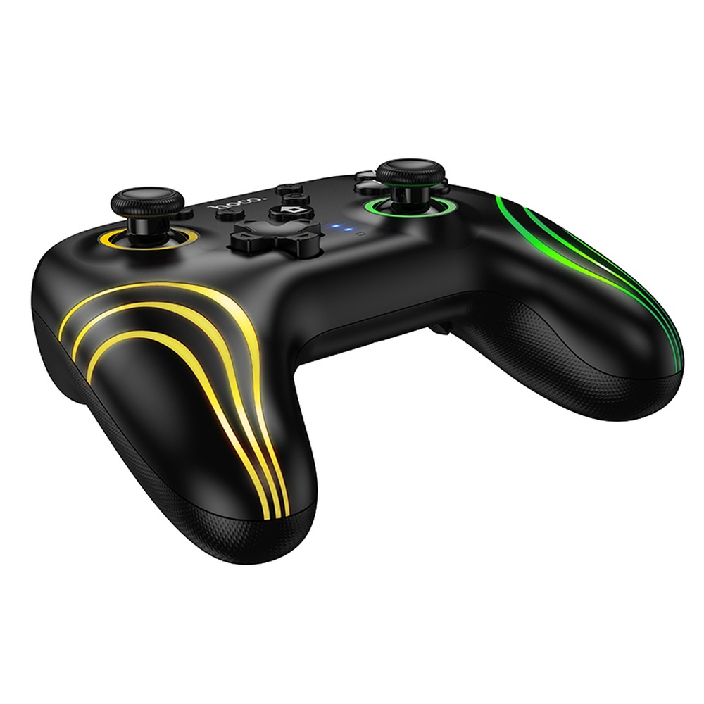 Mando de juegos negro con detalles luminosos amarillos y verdes.