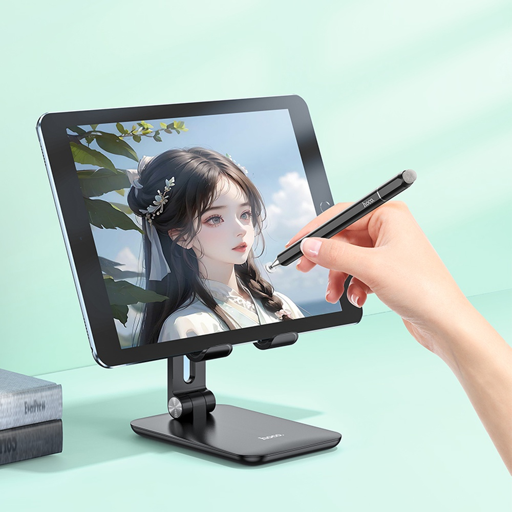 Una mano usa un lápiz óptico negro en una tableta que muestra el retrato de una chica anime.