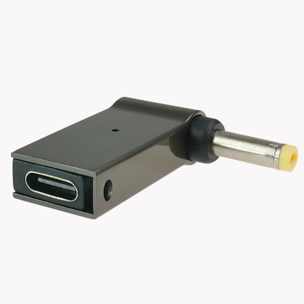 Ciemny adapter USB-C z okrągłą wtyczką. Białe tło.