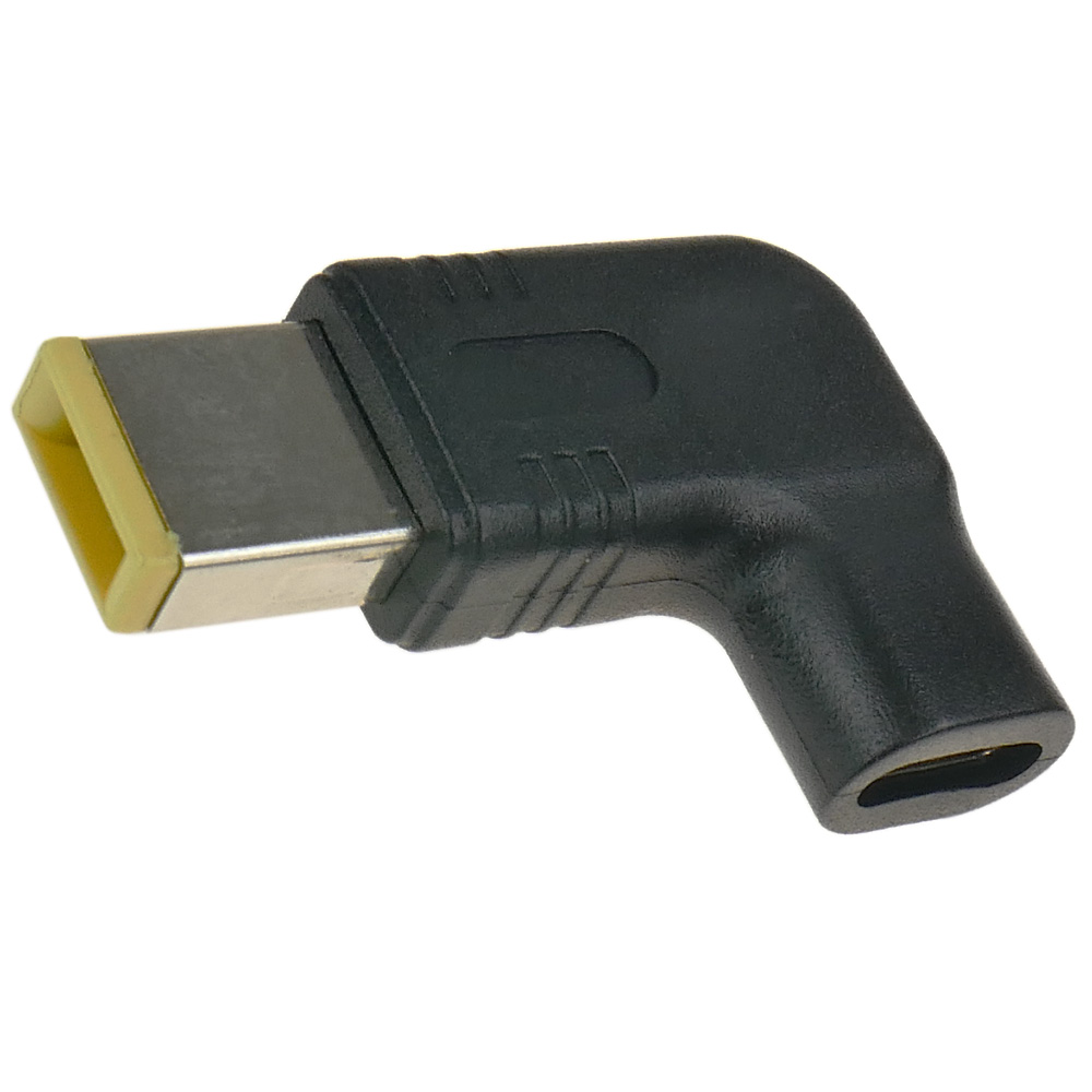 Czarny adapter ze srebrną wtyczką i żółtą krawędzią.