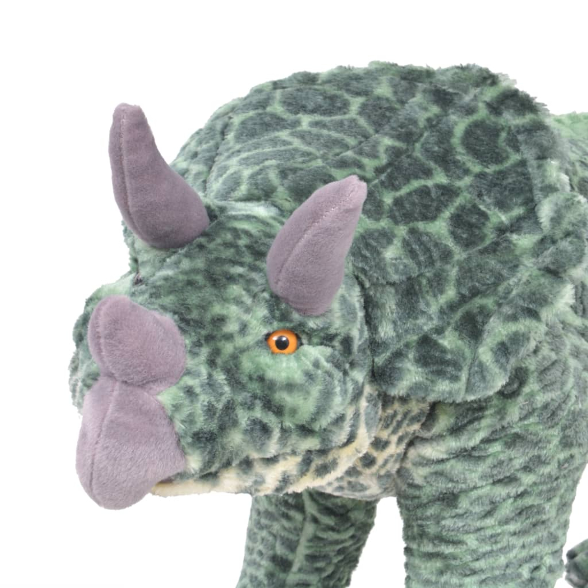Ein grüner Plüsch-Triceratops mit lila Hörnern und einem orangefarbenen Auge.