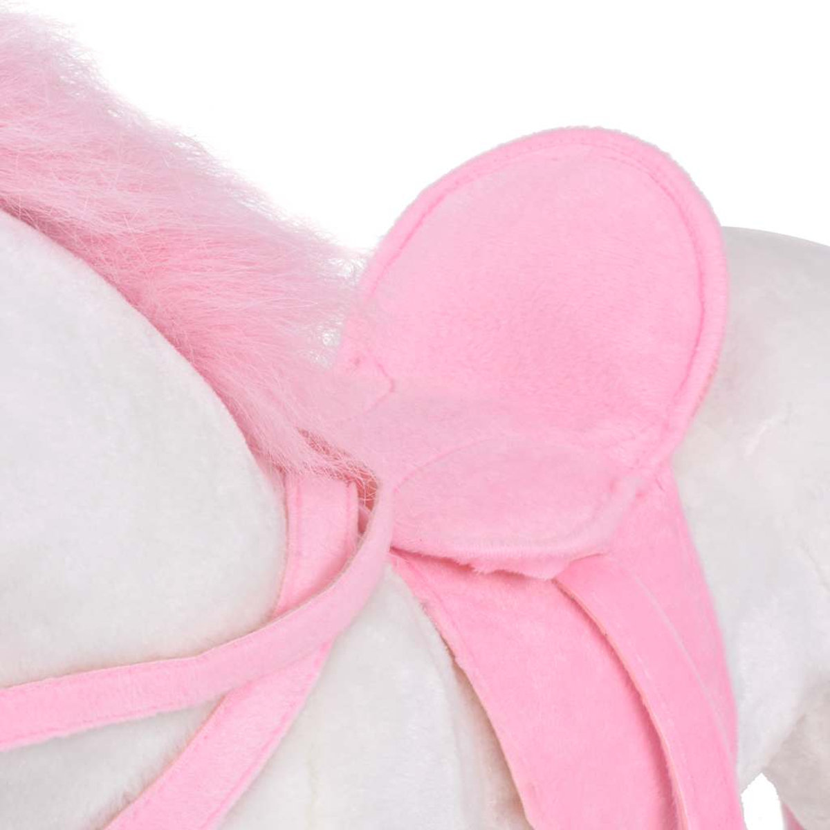Ein weißes Plüschpferd mit rosa Mähne und Sattel.