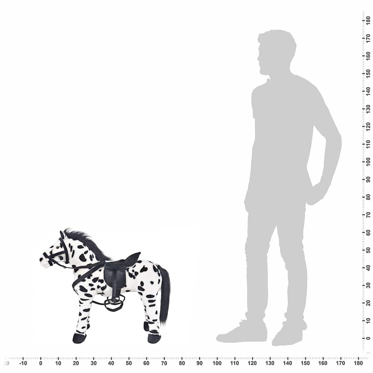 Ein schwarz-weiß geflecktes Spielzeugpferd mit Sattel steht neben einer menschlichen Silhouette.