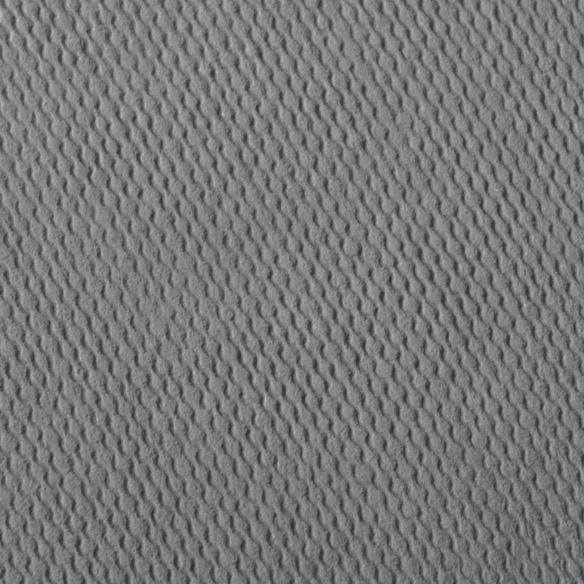 Szara teksturowana powierzchnia z ukośnymi, falistymi grzbietami.