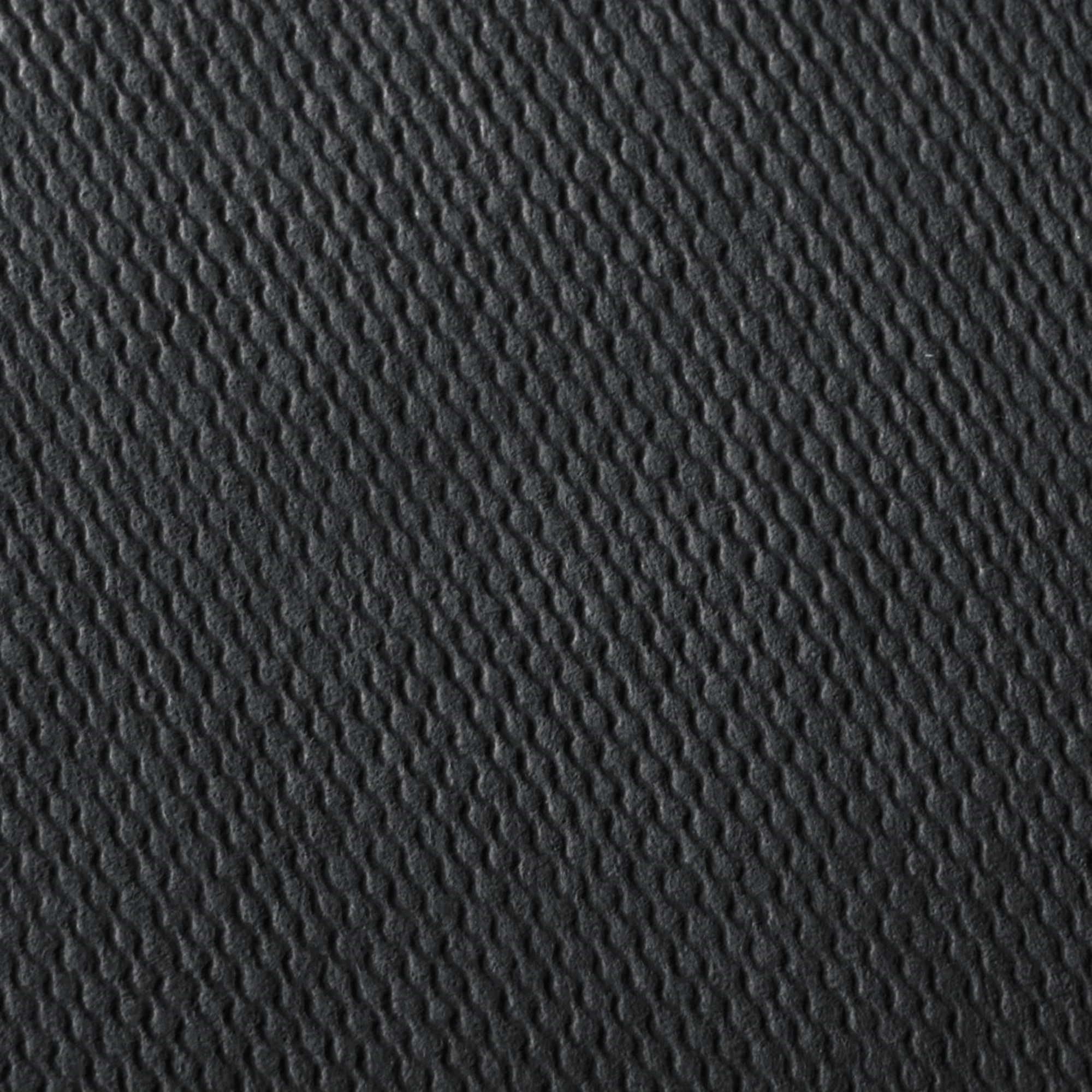 Ciemnoszara powierzchnia z falistą teksturą.