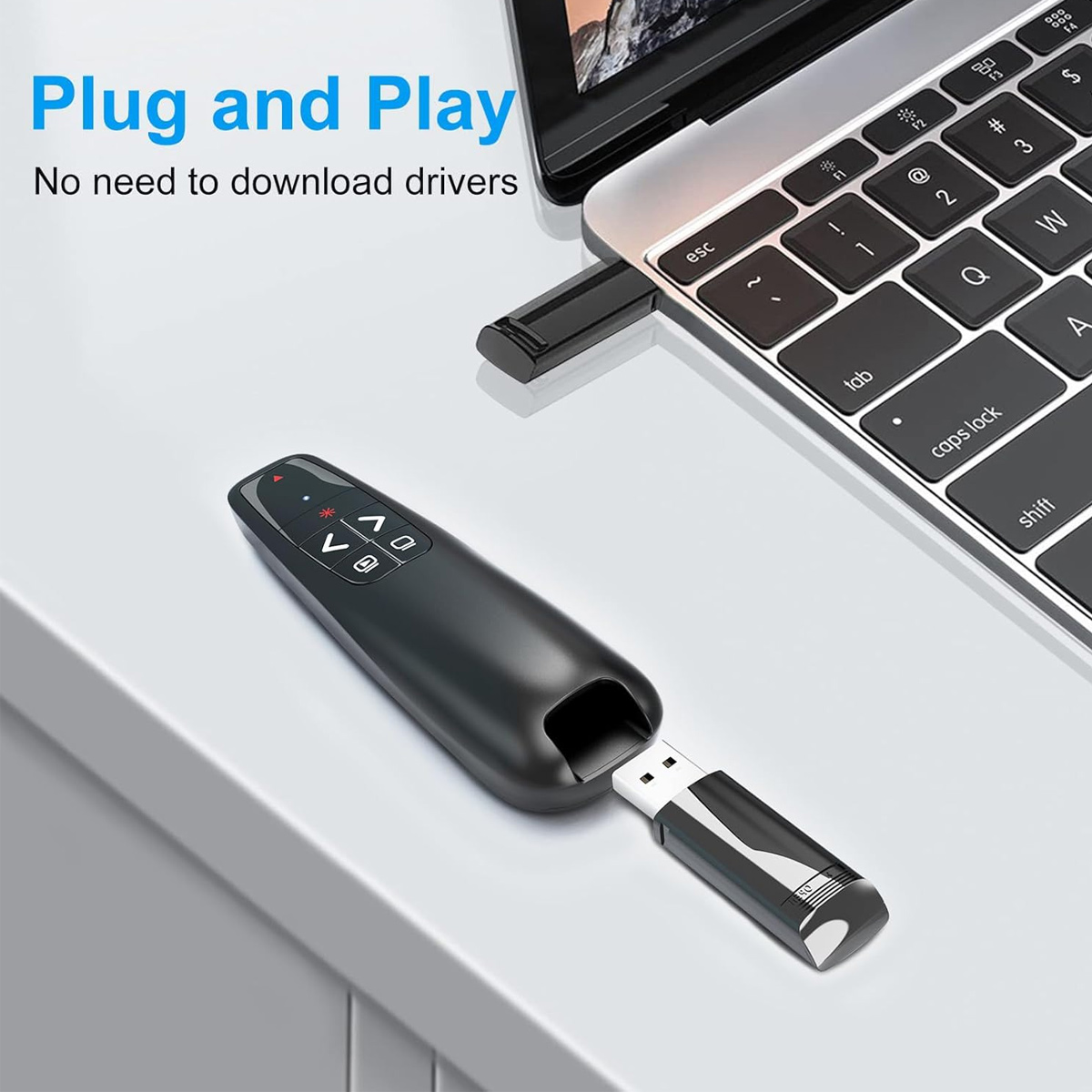 Un telecomando per presentazioni nero con un'unità USB accanto a un laptop.