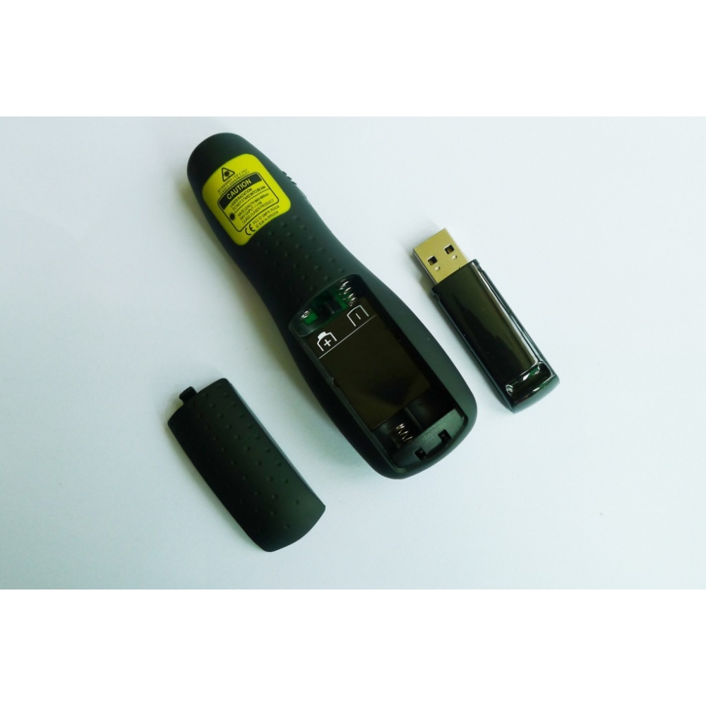Un puntatore laser nero con dongle USB e coperchio batteria rimosso.