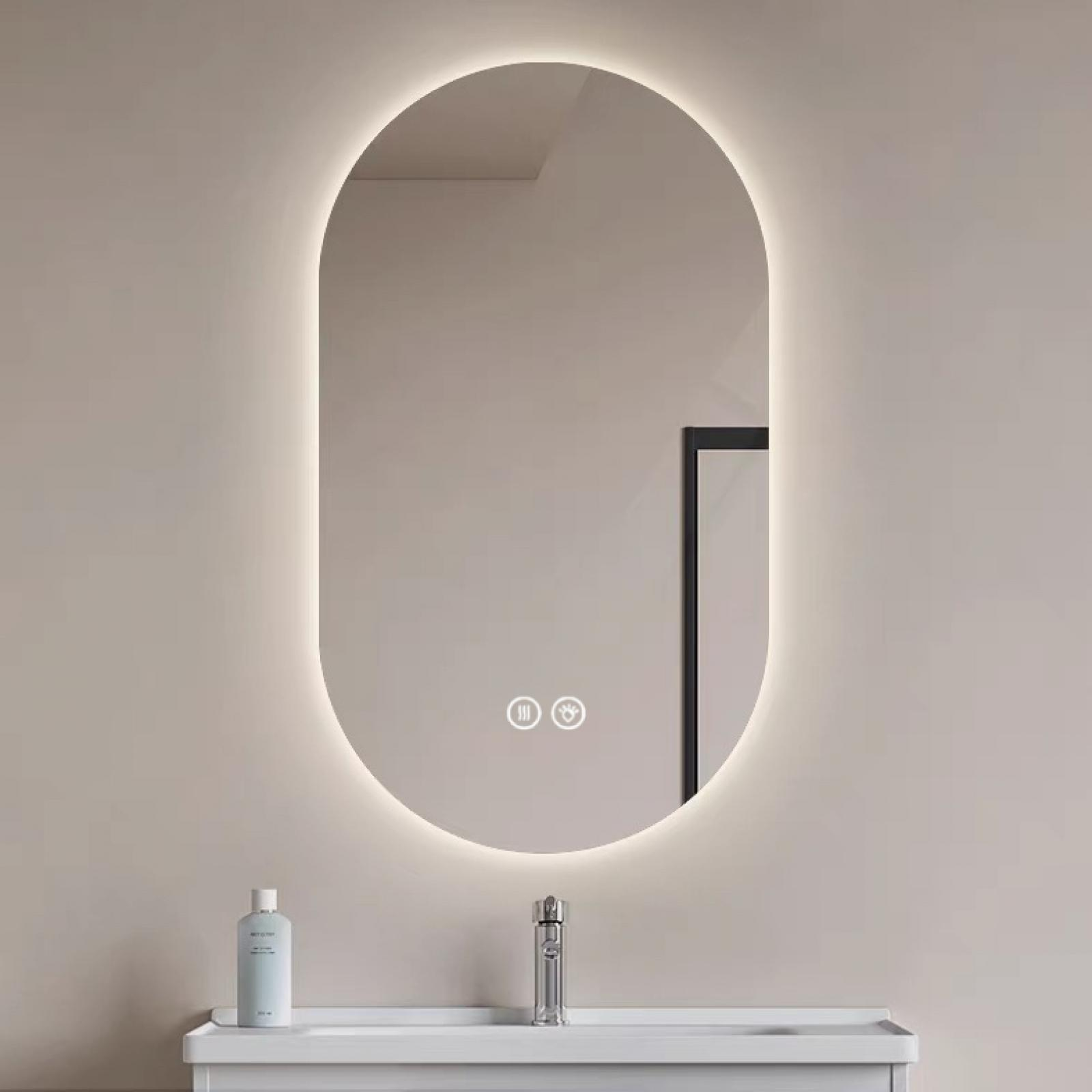 Ein ovaler Spiegel mit LED-Beleuchtung über einem Waschbecken mit Armatur.