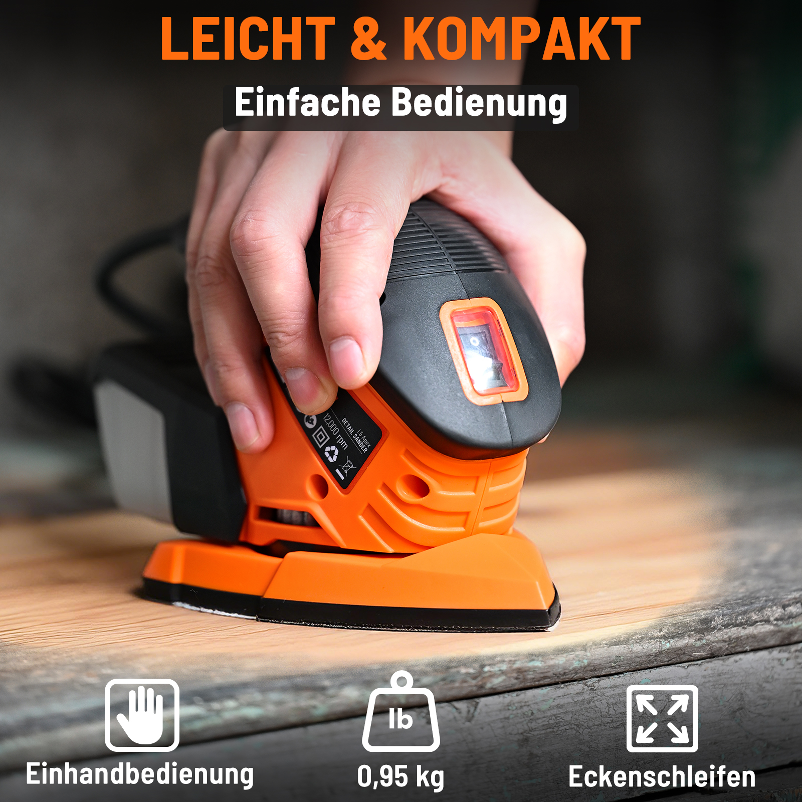 Hand hält orange Detail-Schleifmaschine mit Schalter. Leicht & Kompakt.