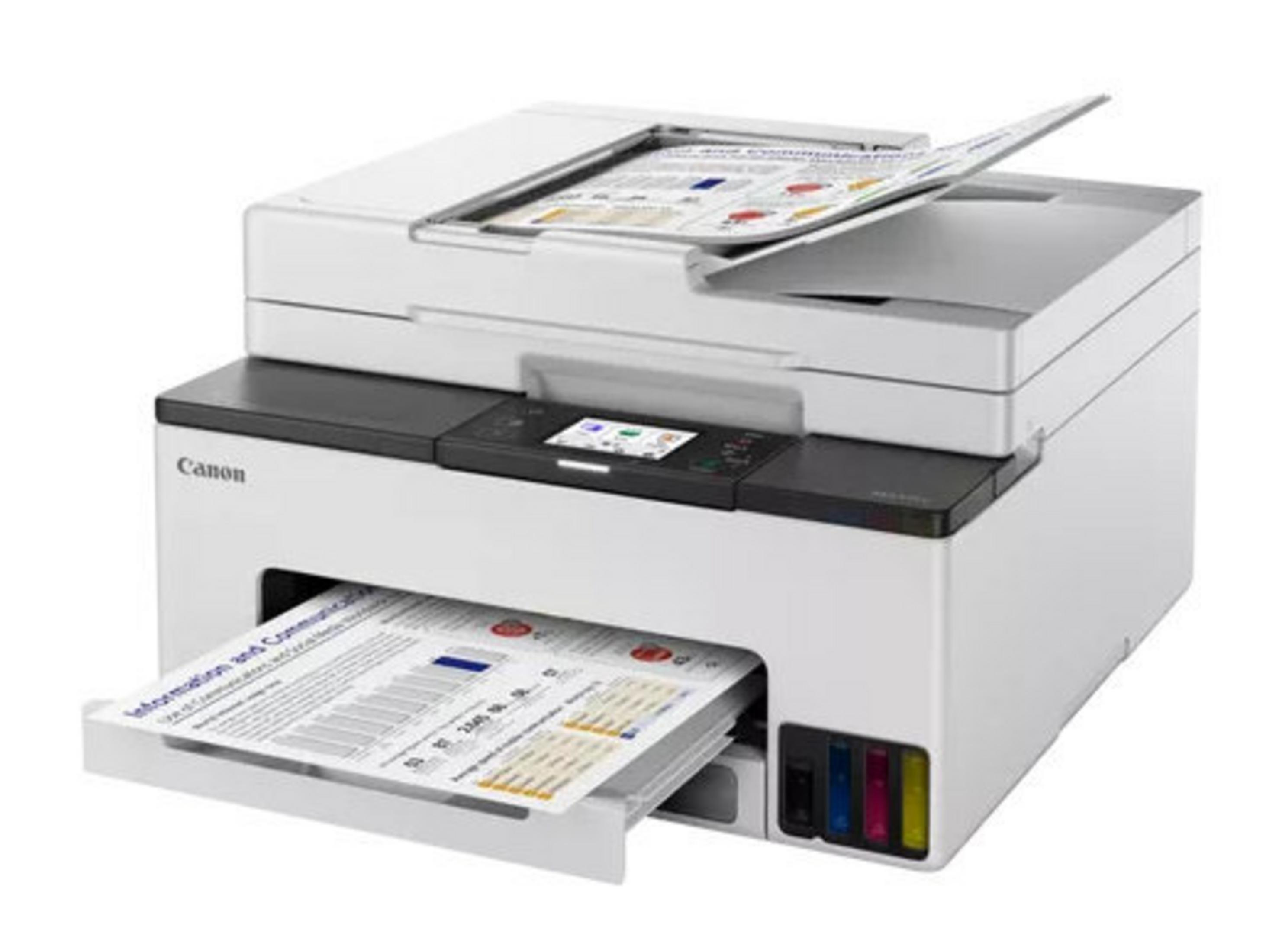 A white Canon printer with paper in the input tray and output tray.