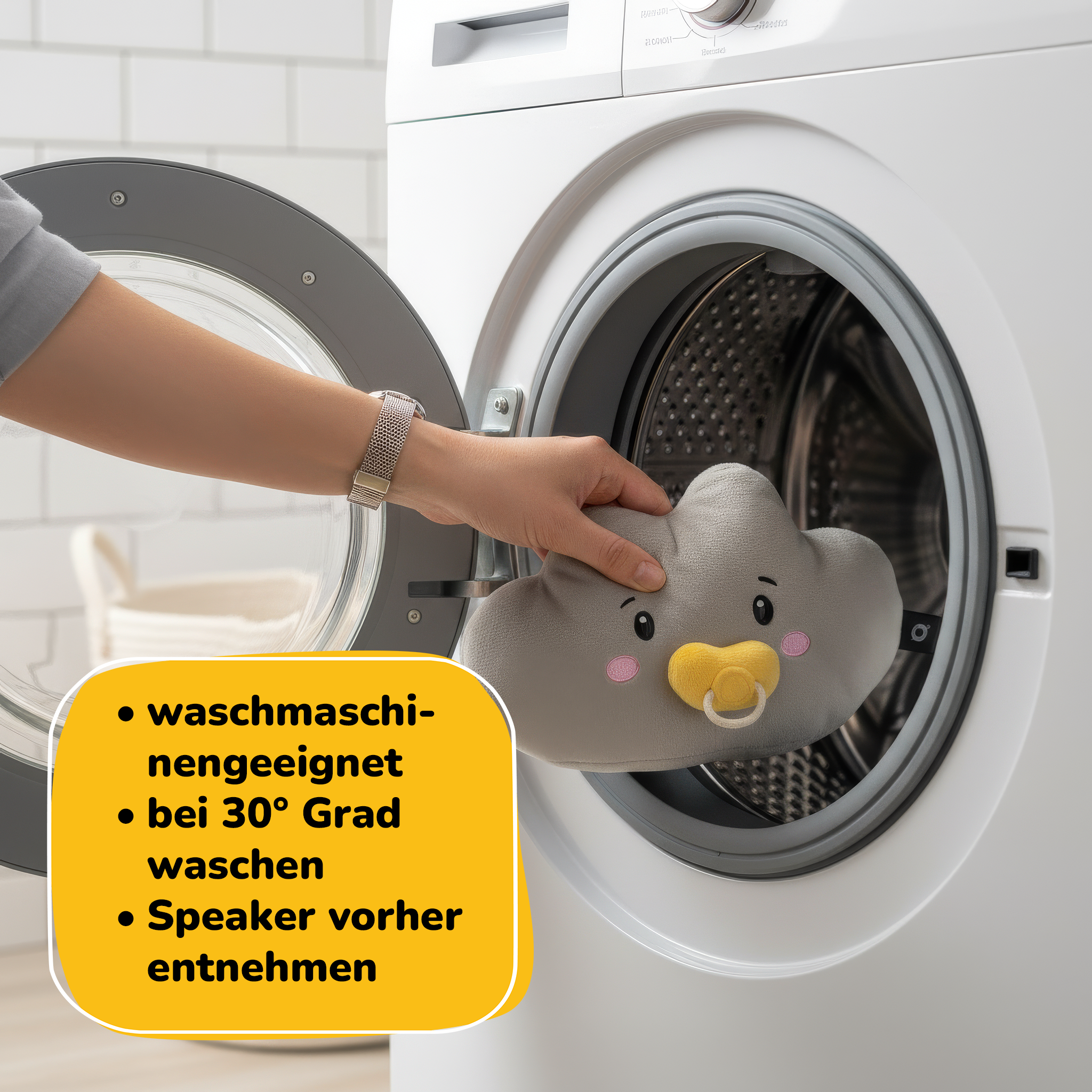 Graue Wolke mit Schnuller wird in Waschmaschine gelegt.