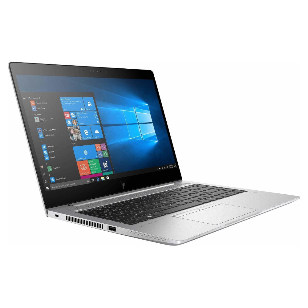 Un ordinateur portable argenté ouvert affichant un écran Windows et un clavier.