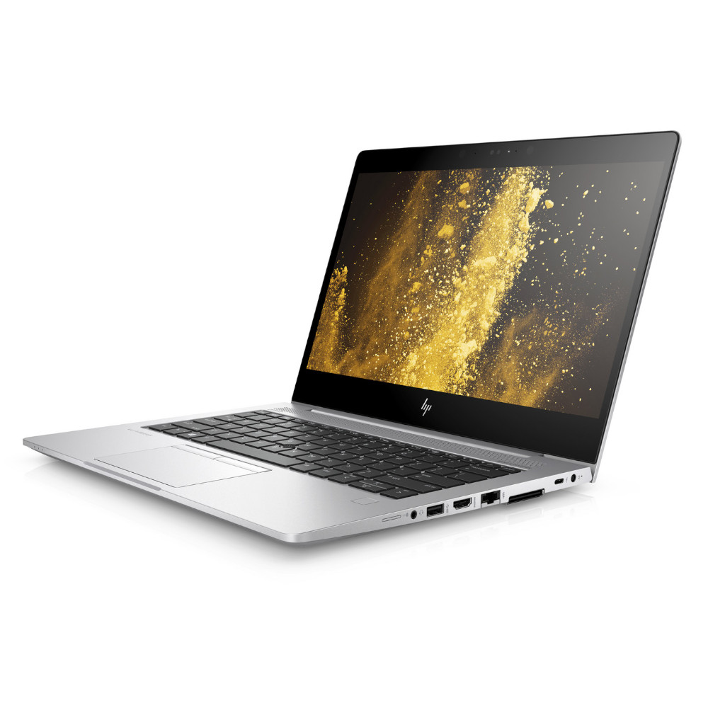Un portátil HP plateado con teclado negro y fondo de pantalla dorado.