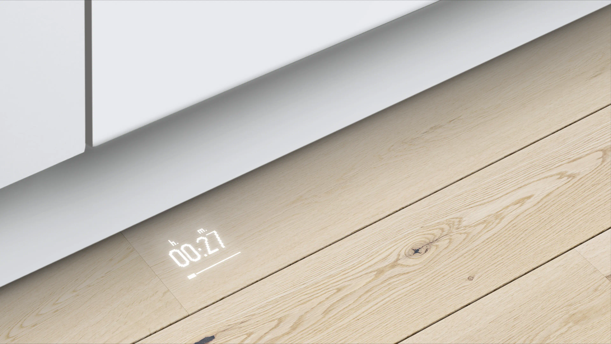 Un temporizador digital muestra 00:27 en un suelo de madera bajo un aparato blanco.