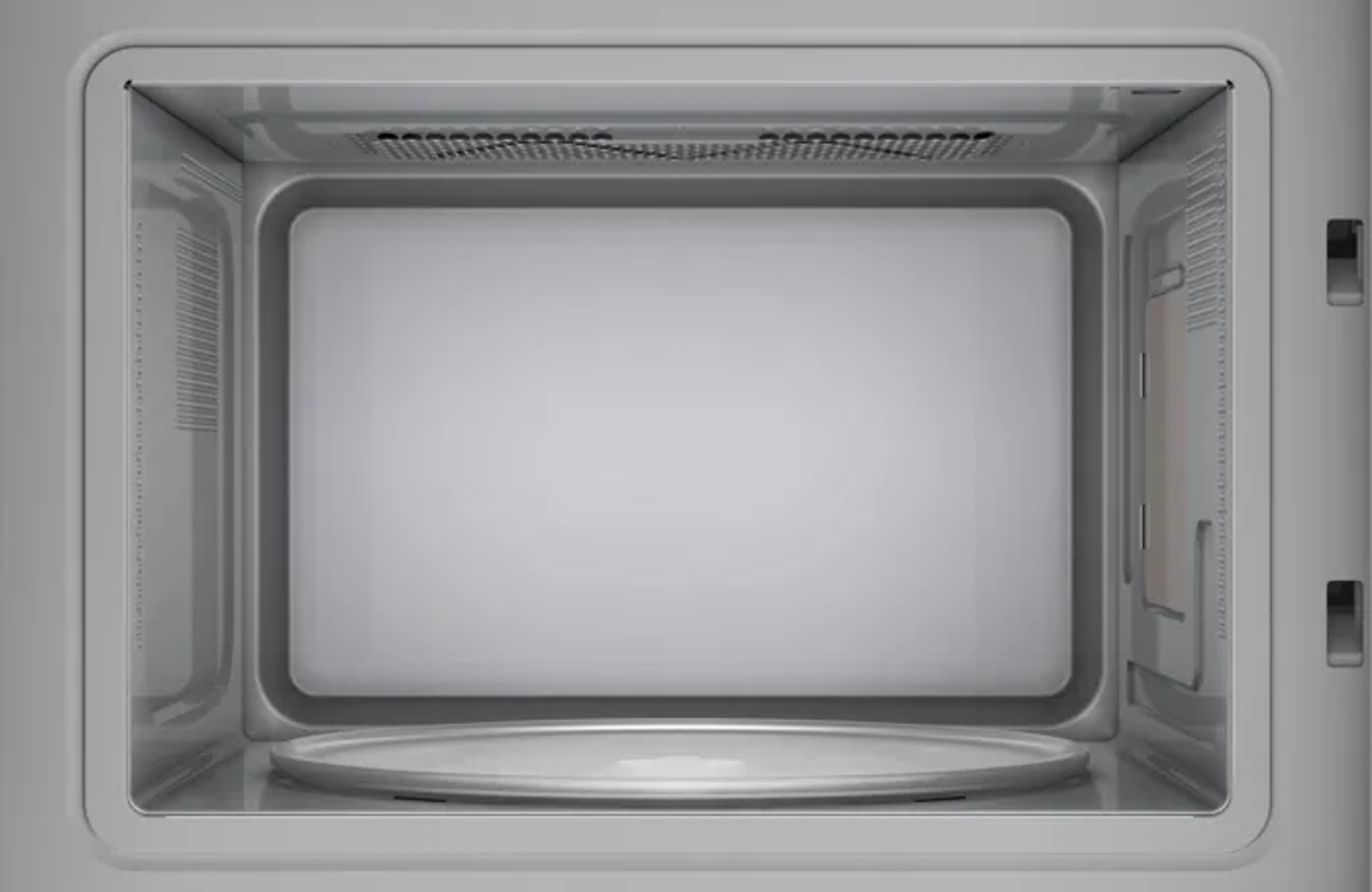 Lege magnetron van binnen met draaiplateau en ventilatie.