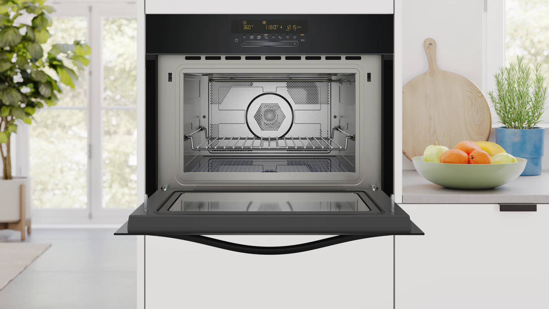 Horno moderno con puerta abierta, interior con rejilla y frutero al lado.