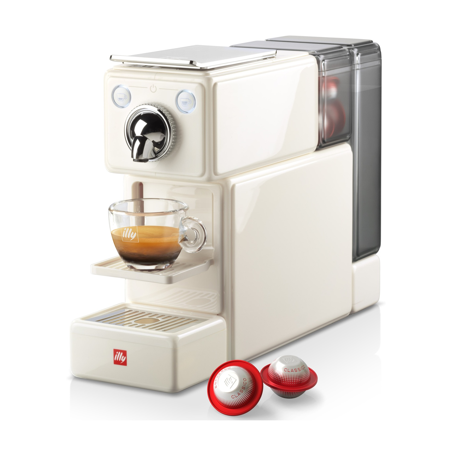 Una macchina da caffè bianca con una tazza di espresso e due capsule.