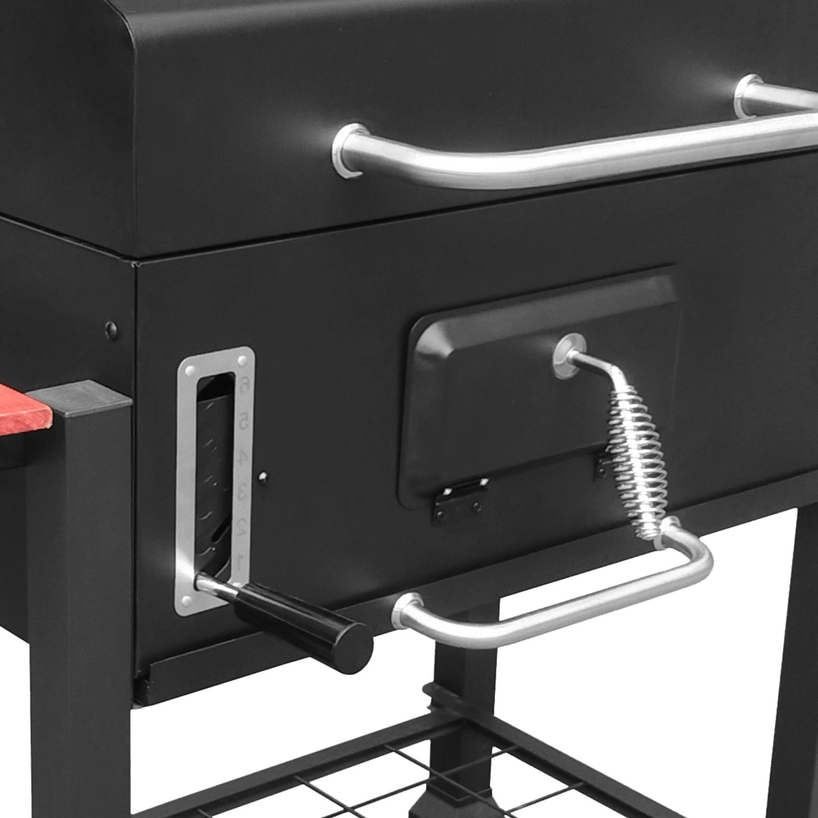 Czarny grill z srebrnymi uchwytami i regulatorami wentylacji.