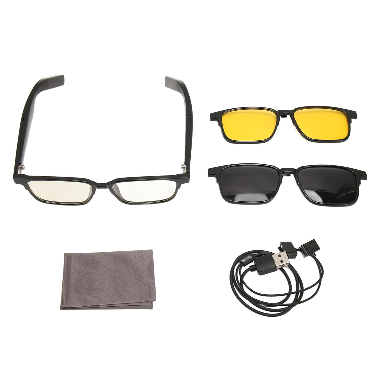 Schwarzer Brillenrahmen mit gelben und schwarzen Aufsteckgläsern, Reinigungstuch und USB-Kabel.