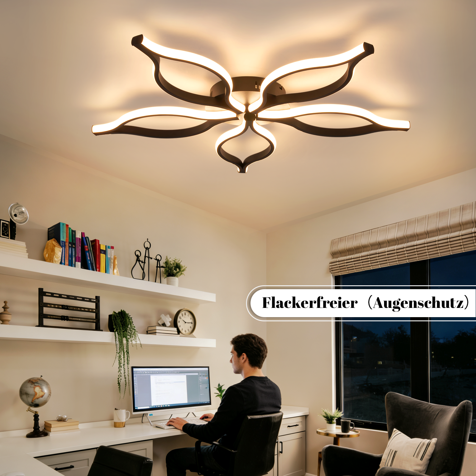 Uomo lavora alla scrivania sotto lampada da soffitto moderna. Scaffali con libri e decori.