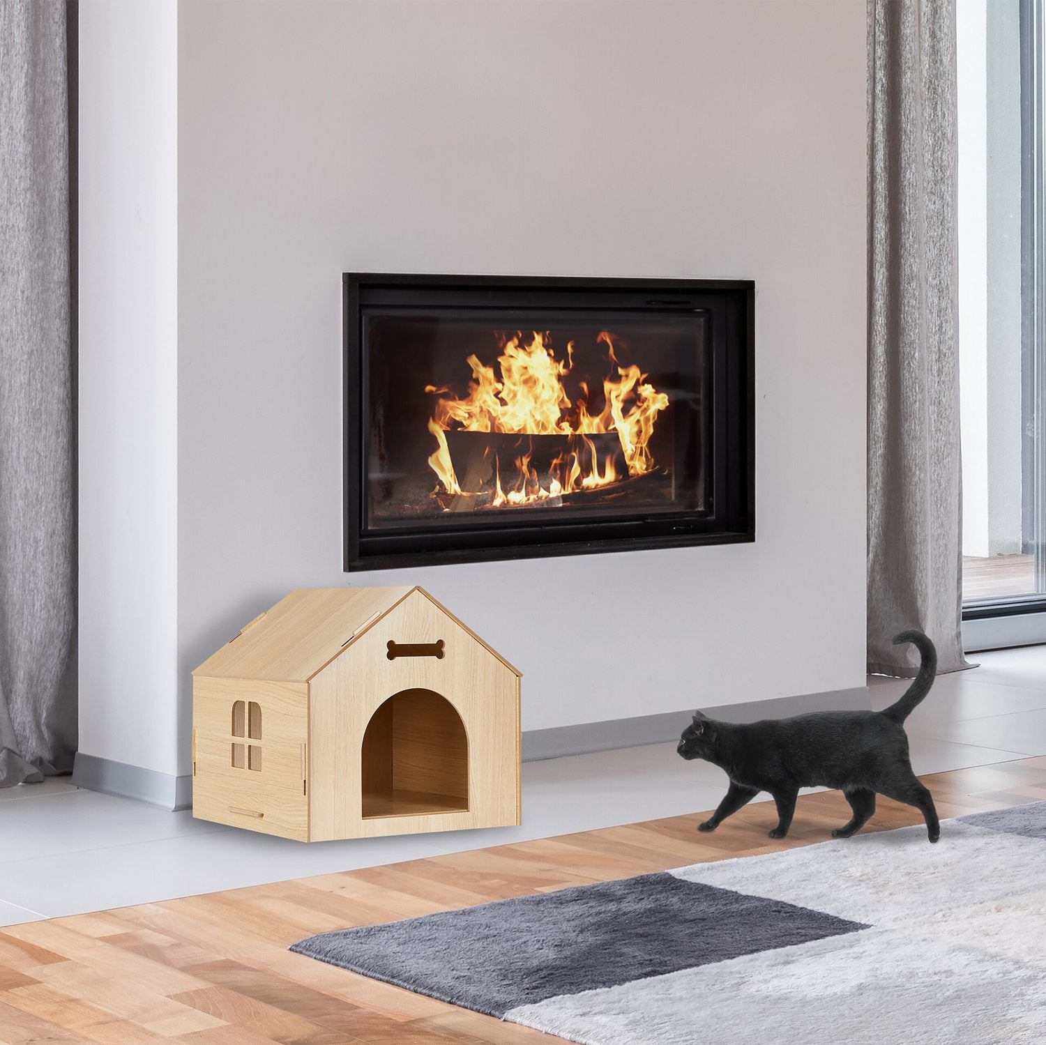 Un gato negro pasa junto a una casa de madera para mascotas y una chimenea con fuego.