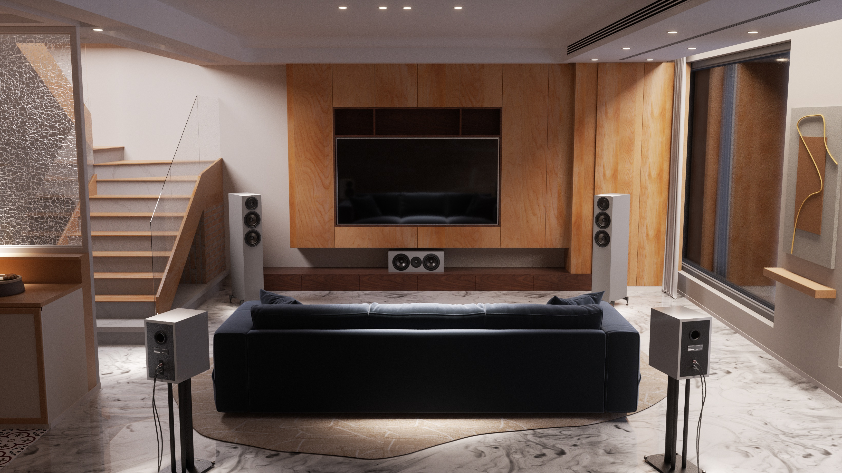 Een moderne woonkamer met donkere bank, scherm, luidsprekers en trap.