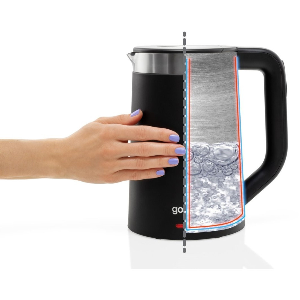 Ręka dotyka przekroju czajnika z wrzącą wodą w środku.