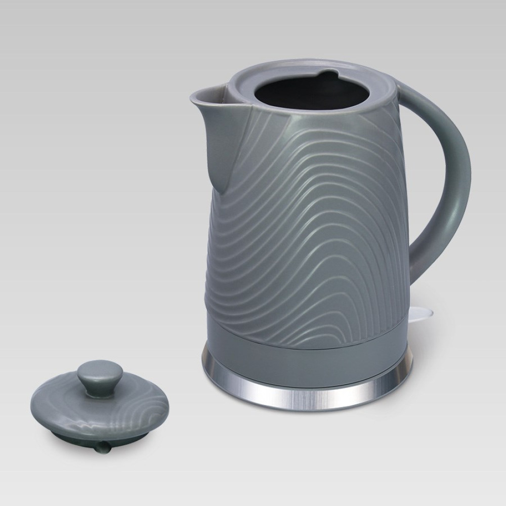 Szary czajnik z falistym wzorem, obok pokrywka.