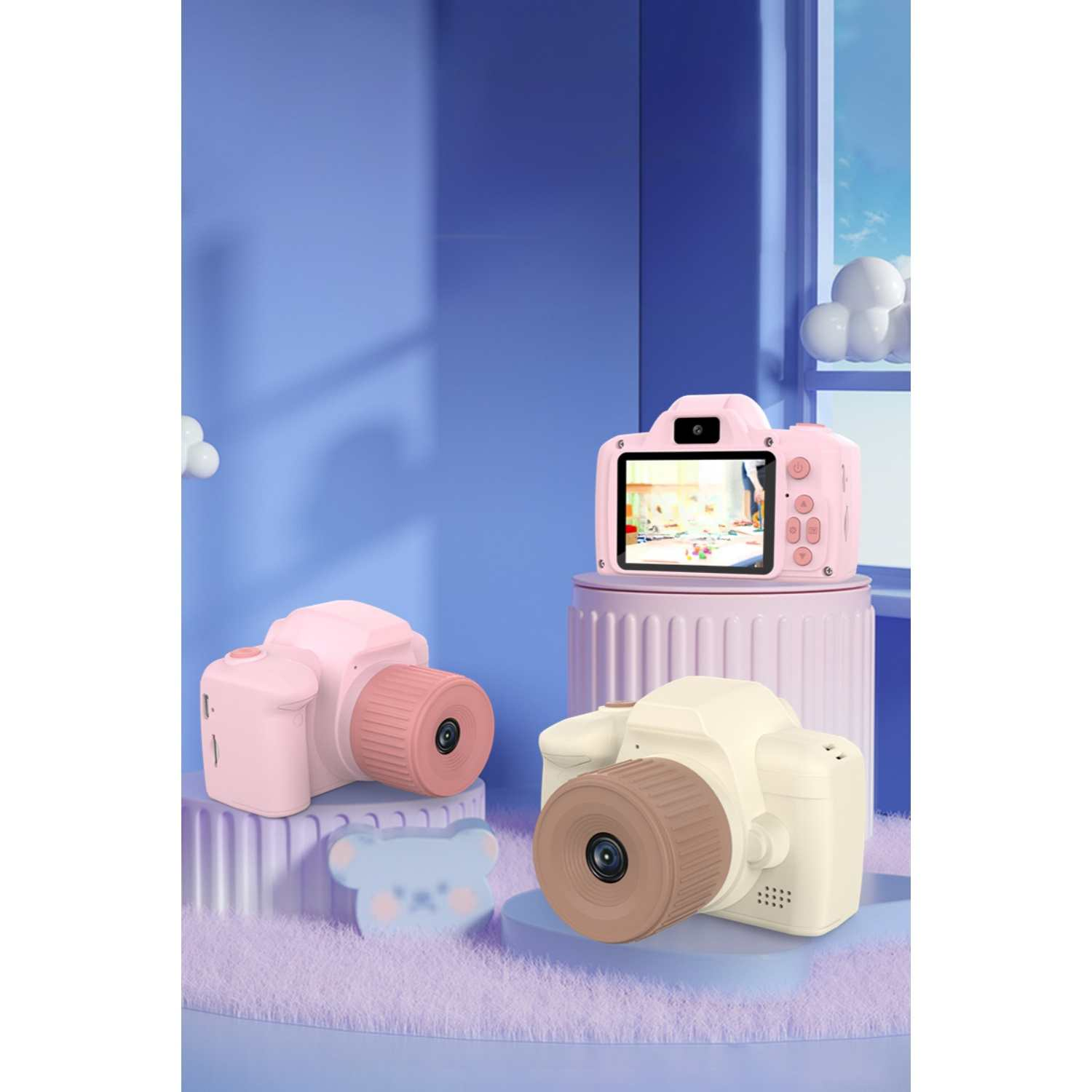 Drei Kinderkameras in Rosa, Cremefarben und Hellrosa auf lila Untergrund.