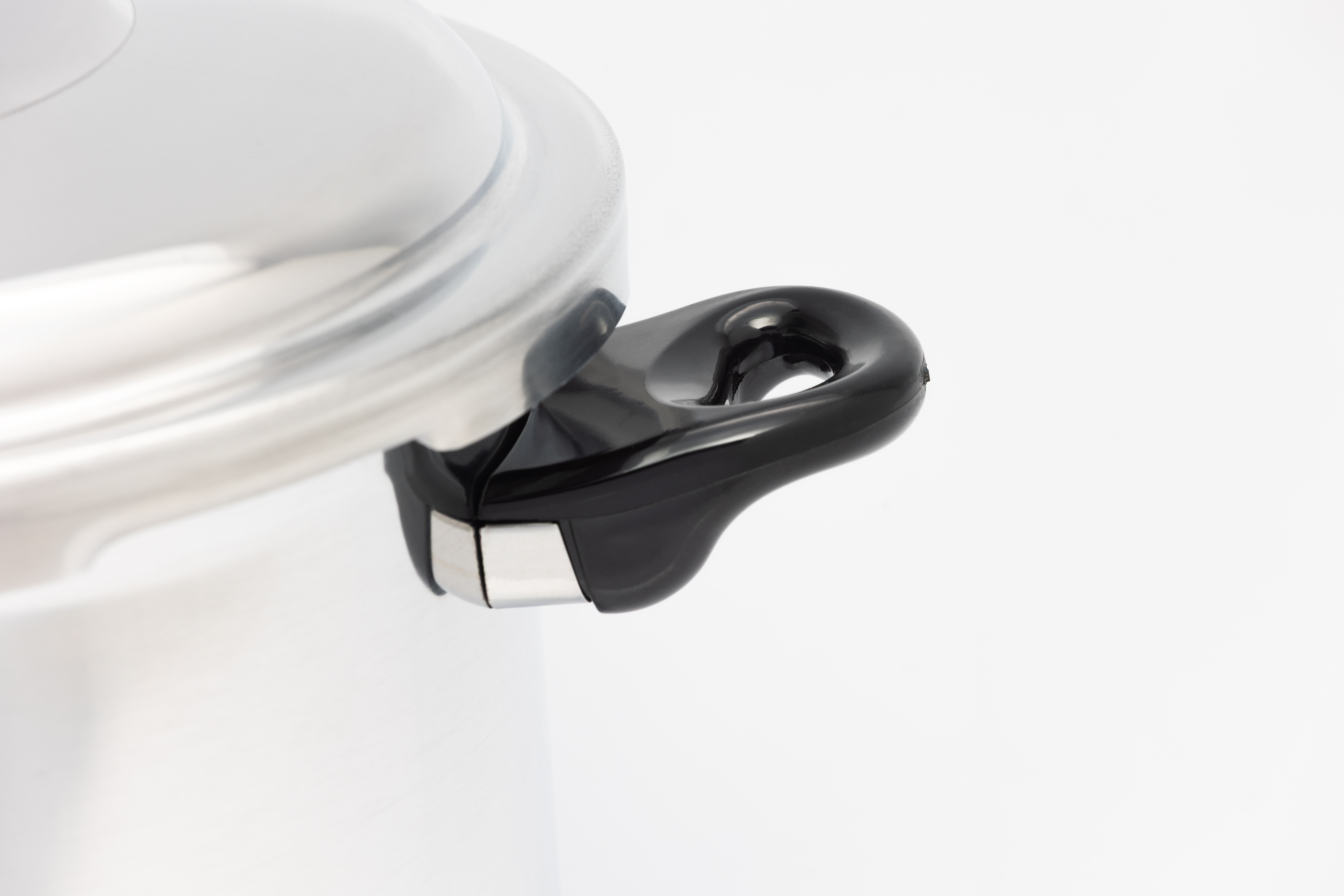 Primer plano de una olla plateada con asa negra y detalles metálicos.