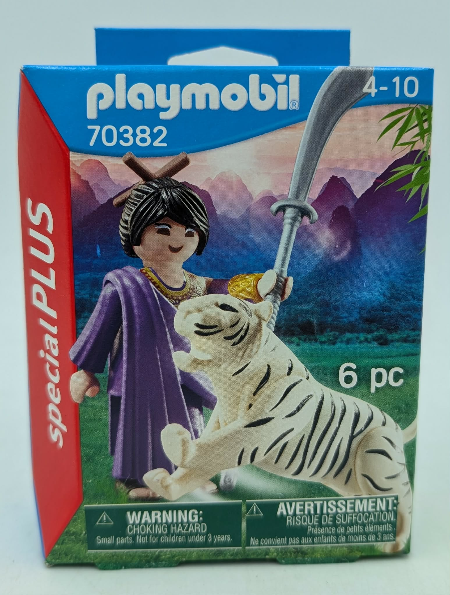 Playmobil figure with white tiger before mountain backdrop. Includes warnings.