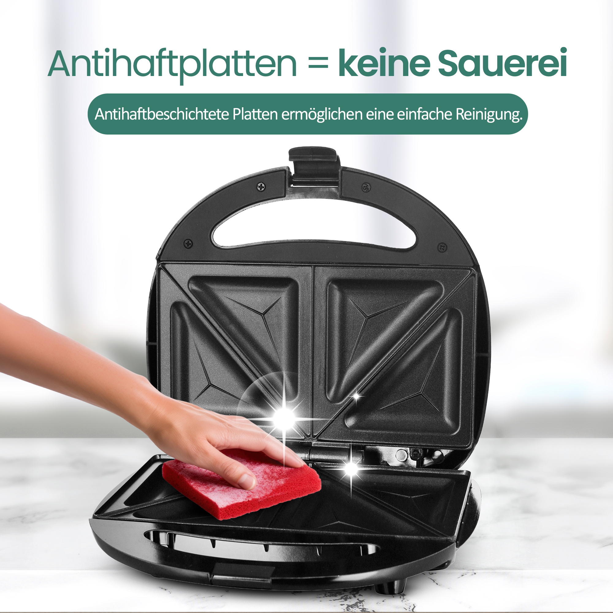 Eine Hand mit rotem Schwamm reinigt die Heizplatte eines offenen Sandwichmakers.