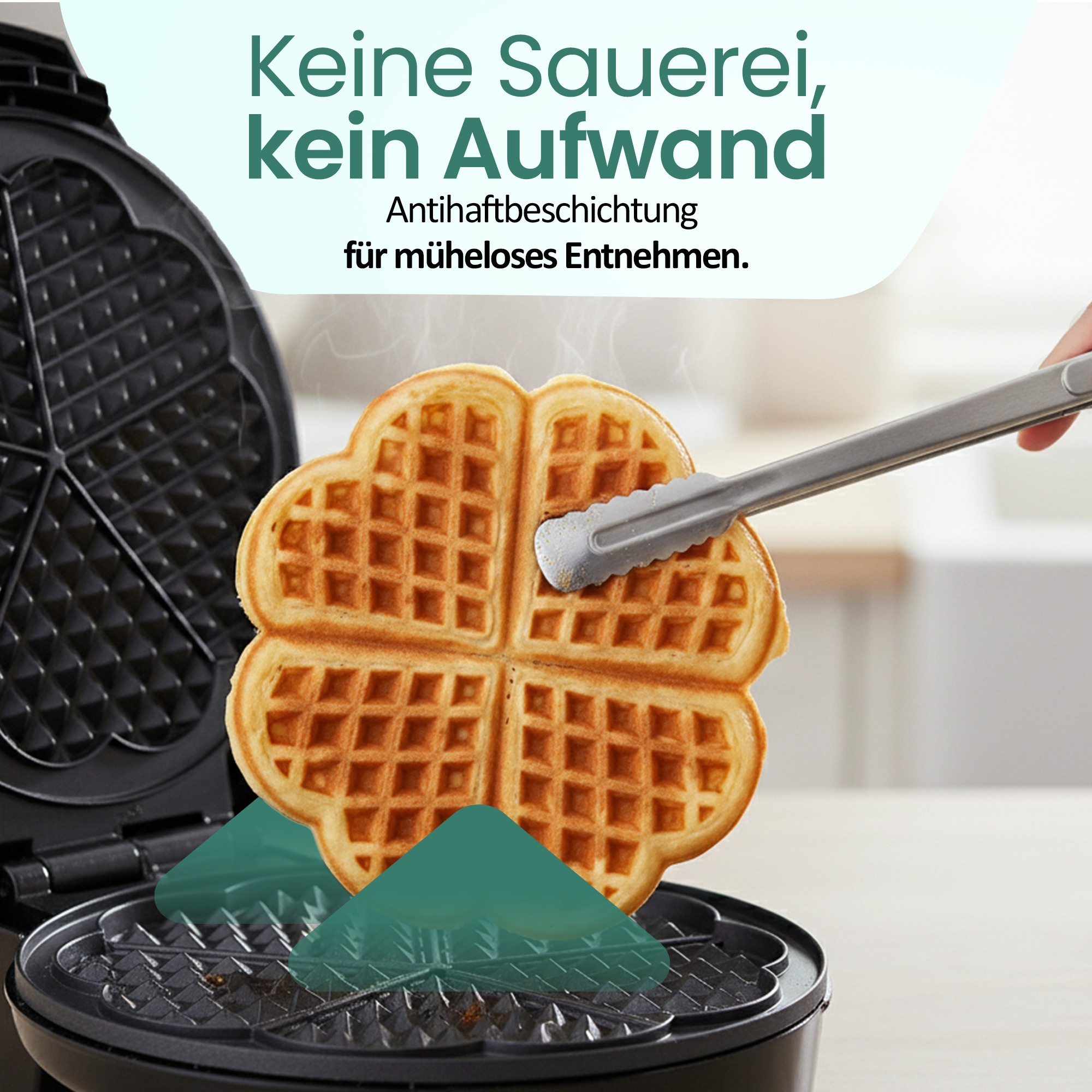 Herzwaffel wird mit einer Zange aus einer offenen Waffelform gehoben.